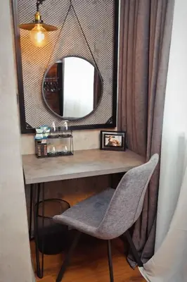 a table with a mirror and a chair in a room at AGIA 2 - cozy one room apartment in Sofia