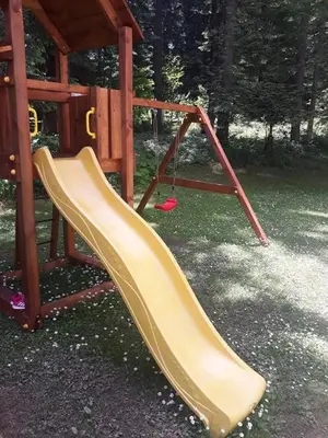 a slide on a playground in a park at Villa Park Guest Apartments in Borovets