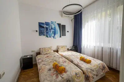 a bedroom with a bed with yellow pillows on it at 7 Seconds Away From the Main Street, FREE Parking in Sofia