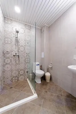 a bathroom with a shower and a toilet and a sink at Апартамент Веирас 2 in Velingrad