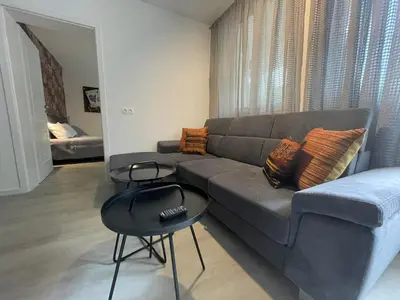 a living room with a couch and a table at Apartament-DEMIAN in Sofia