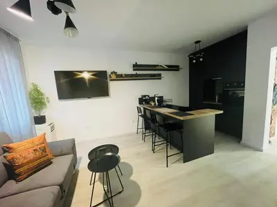 a kitchen and living room with a couch and a table at Apartament-DEMIAN in Sofia