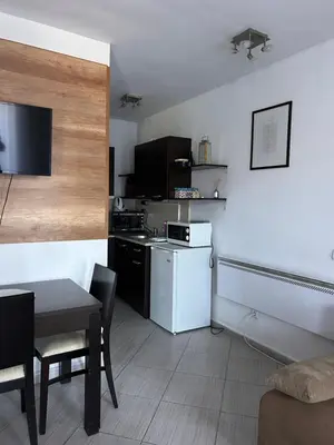 a kitchen with a white refrigerator and a table at B7 Luxury Studio Apartment in Green Life Bansko in Bansko