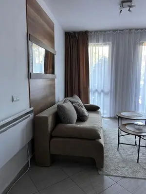 a living room with a couch and a table at B7 Luxury Studio Apartment in Green Life Bansko in Bansko