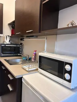 a kitchen with a microwave and a sink at B7 Luxury Studio Apartment in Green Life Bansko in Bansko