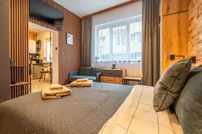 a bedroom with a bed with two towels on it at BB Apartment in Sofia