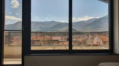 a view from a window of a balcony with mountains at Panorama view apartment in Gotse Delchev
