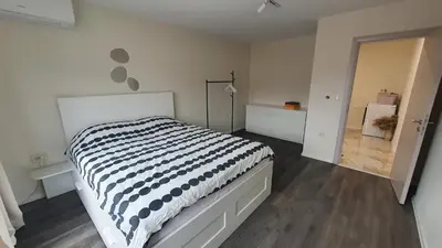 a bedroom with a bed with a black and white comforter at Panorama view apartment in Gotse Delchev