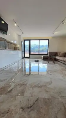 a large living room with a glass floor and a couch at Panorama view apartment in Gotse Delchev