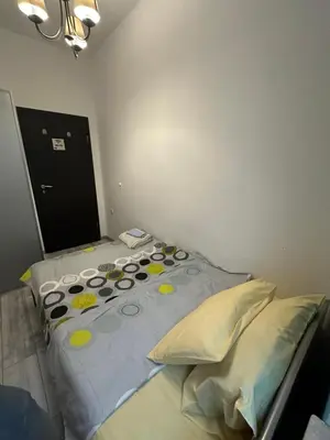 a bed with polka dots and pillows in a room at Comfort Guest Rooms in Plovdiv