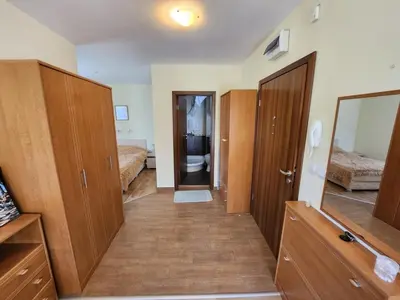 a room with two beds and a hallway with wooden cabinets at Pine tree Easy Ski access - Next 100m to Ski slope and forest view in Bansko