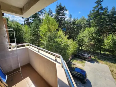 a balcony with a car parked in a parking lot at Pine tree Easy Ski access - Next 100m to Ski slope and forest view in Bansko