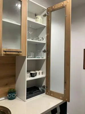 a cupboard with a door open in a kitchen at Apartament Aleksandar Premium in Kyustendil