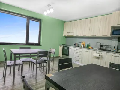 a kitchen with a table and chairs and a dining room at Хостел Стадиона in Pazardzhik