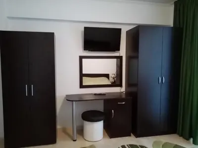 a bedroom with a desk and a mirror and a bed at Апартамент за гости 2Б14 Grand Monastiry in Pamporovo