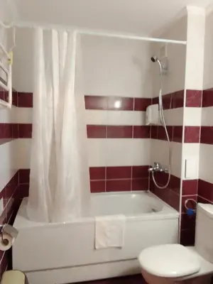 a bathroom with a white tub and a toilet at Апартамент за гости 2Б14 Grand Monastiry in Pamporovo