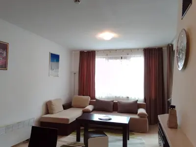 a living room with a couch and a table at Апартамент за гости 2Б14 Grand Monastiry in Pamporovo