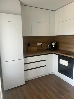 a kitchen with white cabinets and a microwave at ВИЛА ЯНА Villa Yana in Presoka