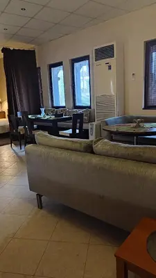 a living room with a couch and a table and chairs at Apartments in Ramada 2 Complex in Bansko