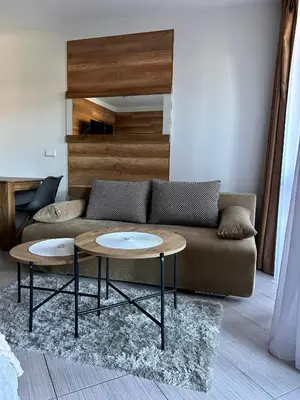a living room with a couch and two tables at B8 Luxury Studio Apartment in Green Life Bansko in Bansko