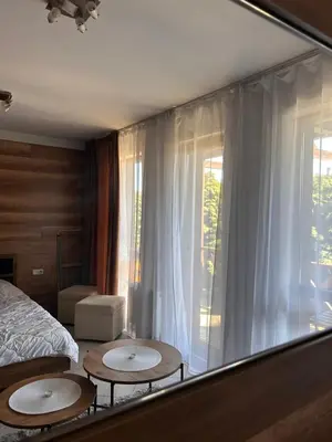 a bedroom with two tables in front of a window at B8 Luxury Studio Apartment in Green Life Bansko in Bansko