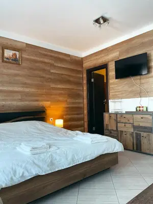 a bedroom with a bed and a flat screen tv at B8 Luxury Studio Apartment in Green Life Bansko in Bansko