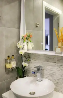 a bathroom with a white sink and a mirror at Luxury Apartment Rich 3 in Velingrad