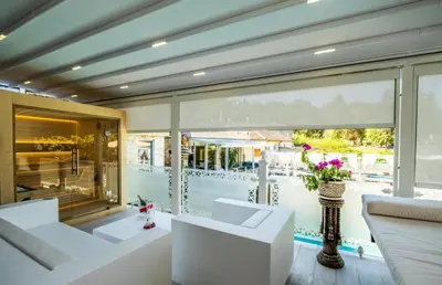 a living room with white furniture and a large window at Luxury Apartment Rich 3 in Velingrad
