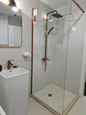 a shower with a glass door in a bathroom at La Maison des Fleurs FREE PARKING in Pazardzhik