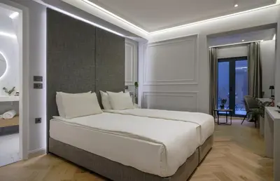 a bedroom with a large bed and a desk at Sentro Boutique Hotel in Sofia
