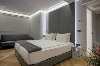 a bedroom with a large white bed with white pillows at Sentro Boutique Hotel in Sofia