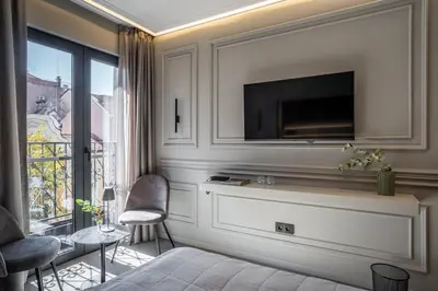 a living room with a television on a wall at Sentro Boutique Hotel in Sofia