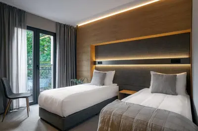 a hotel room with two beds and a window at Sentro Boutique Hotel in Sofia