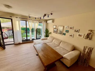 a living room with a couch and a table at Вила Динати in Perushtitsa