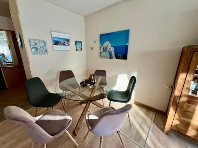a dining room with a glass table and chairs at Вила Динати in Perushtitsa