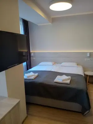 a bedroom with a bed with two towels on it at Hotel Avalon Kyustendil in Kyustendil