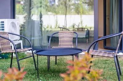 a table and chairs sitting in the grass at Mycampus 1 bdrm, stay 4, free parking, garden, self check-in in Sofia