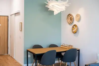 a dining room with a wooden table and chairs at Mycampus 1 bdrm, stay 4, free parking, garden, self check-in in Sofia