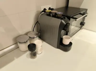 a coffee maker sitting on a counter with cups at Mycampus 1 bdrm, stay 4, free parking, garden, self check-in in Sofia