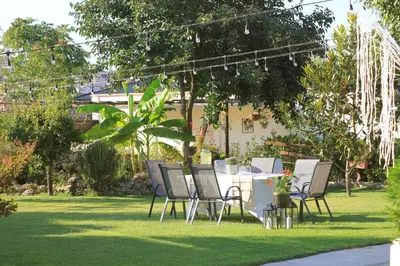 a table and chairs sitting in the grass at Guest House Doni in Sandanski