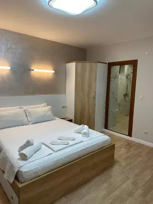 a bedroom with a large bed with towels on it at Guest House Doni in Sandanski
