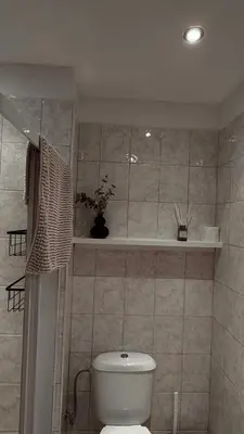 a bathroom with a toilet and a vase on a shelf at Mountain View Apartment with Balcony & Ski Access nearby - Serendipity in Bansko