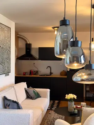 a living room with a couch and a kitchen at Sofia Rooftop Red Apple in Sofia