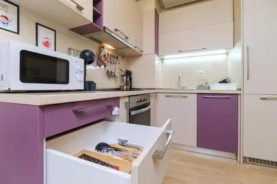 a kitchen with purple cabinets and a microwave at Riverside 2-Bedroom Apartment in Plovdiv