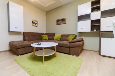 a living room with a couch and a table at Riverside 2-Bedroom Apartment in Plovdiv