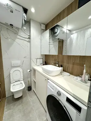 a bathroom with a washing machine and a sink at Central Apartment with Amazing Views in Sofia