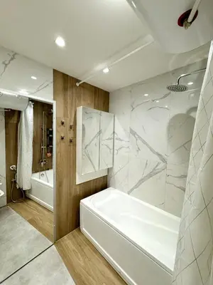a white bathroom with a tub and a shower at Central Apartment with Amazing Views in Sofia