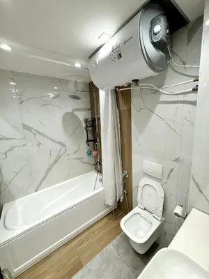 a bathroom with a white tub and a toilet at Central Apartment with Amazing Views in Sofia