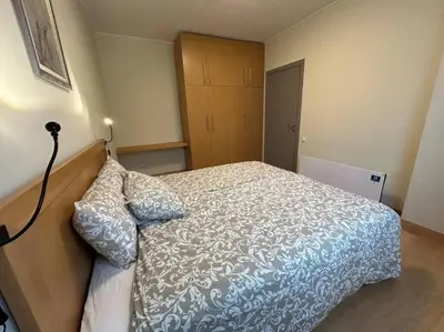 a bedroom with a bed with a blue and white comforter at Silent retreat at Euphoria Club and SPA Borovets in Borovets