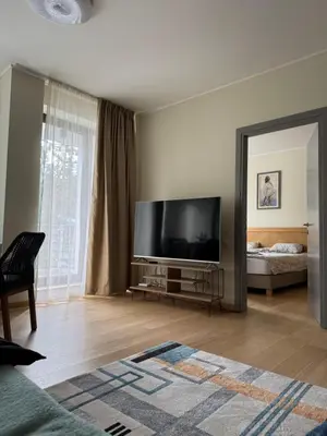 a living room with a large flat screen tv at Silent retreat at Euphoria Club and SPA Borovets in Borovets